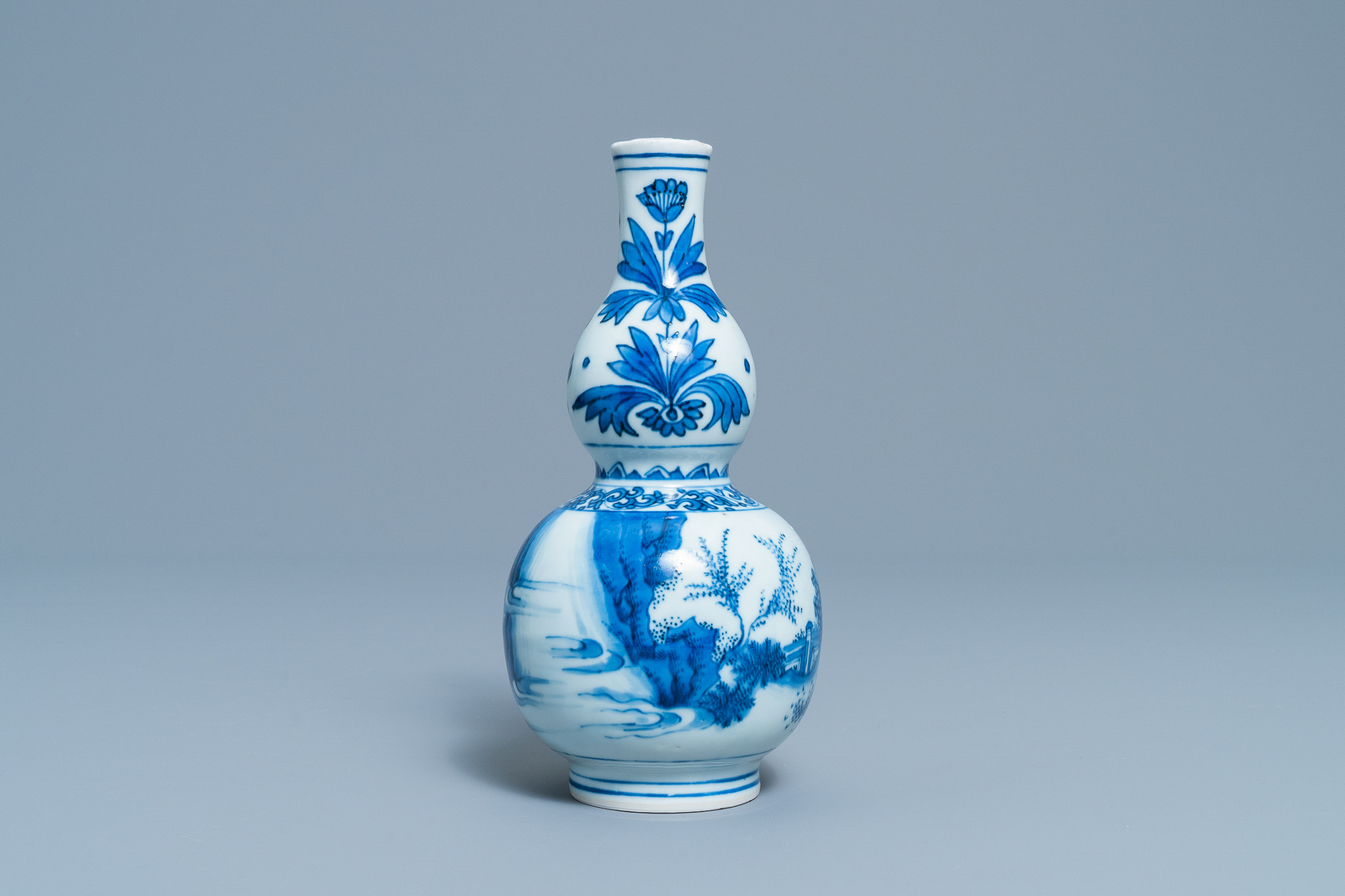 A Chinese blue and white double gourd vase with figures in a landscape, Transitional period - Image 3 of 6