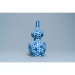 A Chinese blue and white 'lotus scroll' double gourd vase, Wanli