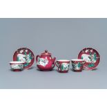 A Chinese famille rose ruby-ground teapot, three cups and two saucers, Yongzheng