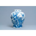 A large Dutch Delft blue and white chinoiserie vase with birds among blossoming branches, 18th C.