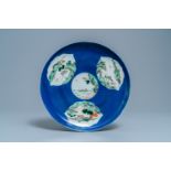 A Chinese famille verte powder blue-ground dish, 19th C.