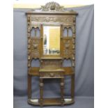 CIRCA 1900 CARVED OAK HALL STAND with mask and fruit detail, central glove drawer and base shelf