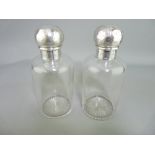 VICTORIAN SILVER TOPPED COLOGNE BOTTLES, a pair, with chase decorated screw mount tops, the