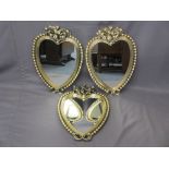 THREE BOBBLE & CHERUBIC GILT DECORATED HEART SHAPED WALL MIRRORS, 59 x 43cm measurements (damage