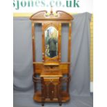 REPRODUCTION MAHOGANY HALL STAND, mirrored centre with brass hooks and shelf above a single