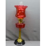 RUBY RED & BRASS VICTORIAN OIL LAMP with black pot base, reeded brass column with ruby font and