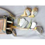 VINTAGE GOLF CLUBS IN CARRY CASE including two wooden shafted examples, one marked 'The Uot Putter'
