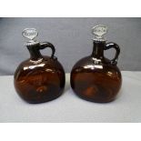 19TH CENTURY AMBER GLASS SPIRIT FLAGONS, a pair, having white metal collar mounts and mother of