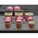 FIFTEEN VICTORIAN PINK POTTERY CHEMIST JARS with mercury type glass labels, some with original