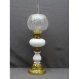 BRASS & WHITE MILK GLASS VICTORIAN OIL LAMP with decoration in relief and frosted globular shade,