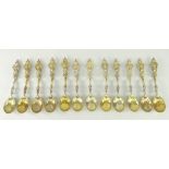 TWELVE UNITED KINGDOM CREST SILVER SPOONS gilded and decorated in relief, six fully hallmarked for