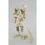 MEIJI PERIOD IVORY OKIMONO SECTIONAL FIGURE OF A FISHERMAN WITH NET, on naturalistic base, red