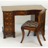 NEAT REPRODUCTION MAHOGANY SERPENTINE DESK with tooled leather writing surface and pair of