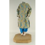 ORIENTAL DRESSED MANNEQUIN ON A WOODEN STAND