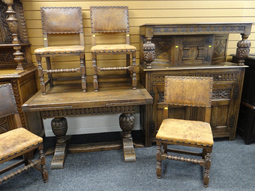 ELIZABETHAN STYLE CARVED OAK DINING SUITE comprising draw leaf table (7 feet long), four leather