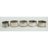 SET OF FOUR 800 SILVER NAPKIN RINGS, together with another silver British napkin ring (5)