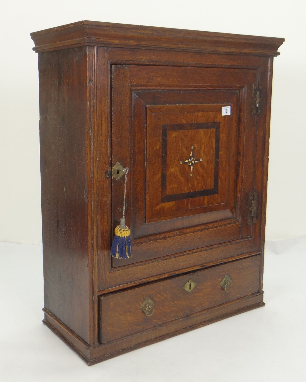 GOOD MID 18TH CENTURY JOINED OAK MURAL CUPBOARD, pediment above paneled door, with feather strung