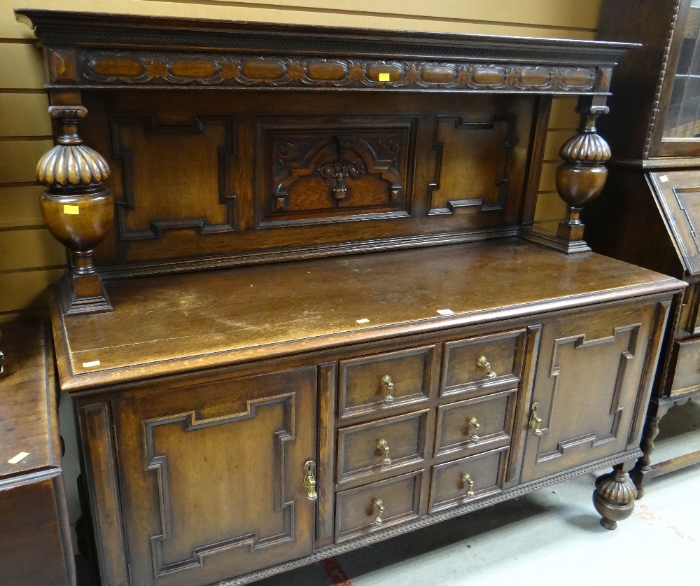 GOOD VINTAGE CARVED OAK SIDEBOARD on fluted bulbous supports, flanking cupbopards, one with