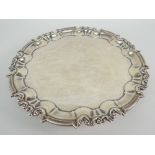 EDWARD VII SMALL SILVER SALVER having scroll and pointed border raised on three scroll feet,