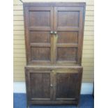 CIRCA 1820 NORTH WALES OAK PRESS CUPBOARD, two piece of peg joined construction having twin upper