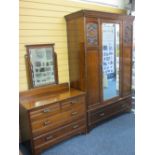 CIRCA 1910 TWO PIECE MAHOGANY BEDROOM SUITE of single mirrored door wardrobe with carved detail to