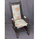 CIRCA 1900 AMERICAN ROCKER with floral re-upholstery, 108cms H, 54cms W, 45cms seat D