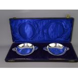 COLONIAL SILVER DISHES, a boxed pair, with shallow bowls and double handles in Art Deco form, c1920,