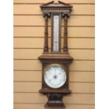 CIRCA 1900 OAK FRAMED ANEROID BAROMETER WITH THERMOMETER in the architectural style, 92cms H,
