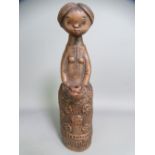 MARGIT KOVACS POTTERY FIGURINE of a young girl holding a jug, incised monogram to the base, 23cms