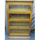 OAK WERNICKE STYLE STACKING BOOKCASE, four section with associated base and top, the upper flap door