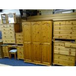 EIGHT PIECES OF MODERN PINE BEDROOM FURNITURE including a three door wardrobe, pedestal dressing