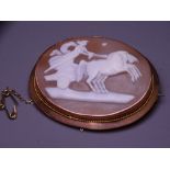 LARGE NINE CARAT GOLD FRAMED CAMEO BROOCH, the 4.5cms cameo carved with a Greek Goddess in a horse