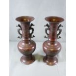 PAIR OF BRONZE ORIENTAL VASES with seahorse handles, 33cms H