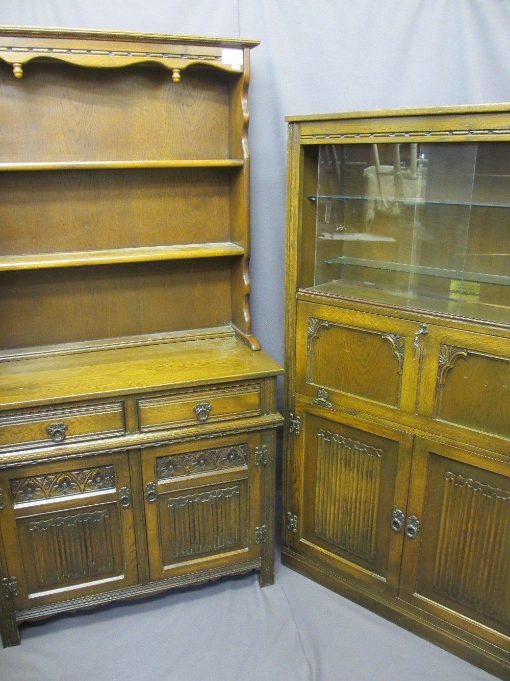 TWO ITEMS OF PRIORY STYLE FURNITURE with linenfold carving including a two door, two drawer dresser,
