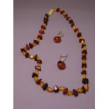 AMBER BEAD NECKLACE of natural form and a pair of earrings