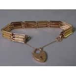NINE CARAT GOLD FOUR BAR GATE LINK BRACELET with padlock clasp and safety chain, 18.9grms gross