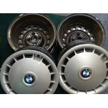 SET OF FOUR BMW WHEELS with clip-on plastic trims (see image for sizes)