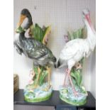PAIR OF CONTINENTAL POTTERY STICKSTANDS, a fine pair depicting storks and lilies (A/F), 92cms H