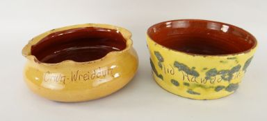 TWO EWENNY POTTERY BOWLS slip decorated, incised to one with 'Cwn-wreiddyn', the other 'Nid hawdd *