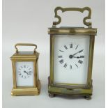 TWO CARRIAGE CLOCKS comprising boudoir carriage clock and another larger (glazed door loose),