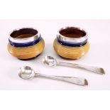ROYAL DOULTON STONEWARE SALTS with silver collars and two hallmarked silver spoons