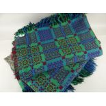 PAIR OF WELSH BLANKETS woven blue, green and red with fringes (one faded)