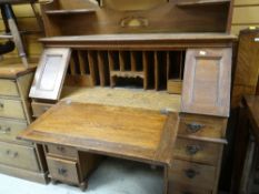 VINTAGE SLOPED BUREAU with bank of drawers and rail top