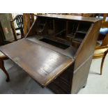 EDWARDIAN OAK BUREAU having fitted three long drawers, fitted interior