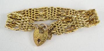 9CT YELLOW GOLD GATE LINK BRACELET with florally engraved heart shaped padlock, 12.1gms overall