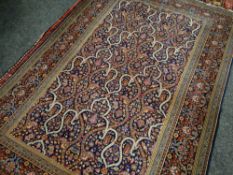 PERSIAN GARDEN RUG with indigo field, stylized flowers, arabesque compartments, lotus border,