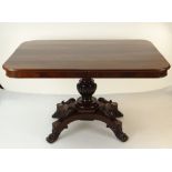 WILLIAM IV FLAME MAHOGANY BREAKFAST TABLE, rectangular tilt action top, on elaborate carved column