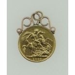 VICTORIAN GOLD SOVEREIGN DATED 1889 with yellow metal scroll mount, 9.0 grams overall.