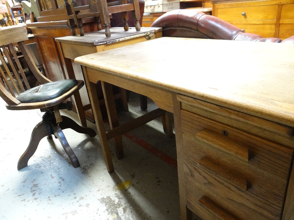 THREE VINTAGE FURNITURE ITEMS comprising oak student's desk, another school desk and a revolving