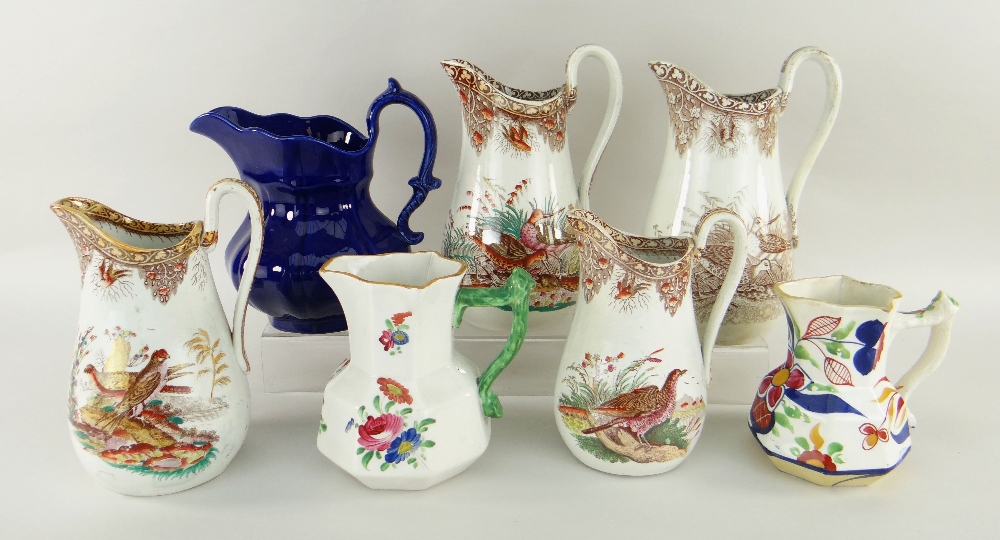 WELSH POTTERY JUGS four Cambrian brown printed jugs, sporting birds, three other Welsh jugs, one